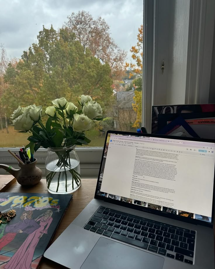 A laptop by the window.